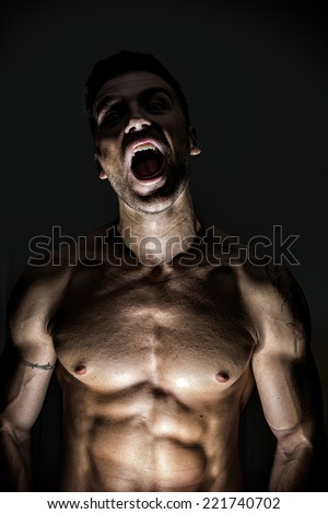 Close up Illuminated Sexy Werewolf Man Opening His Mouth on Gray Background. Studio Shoot.