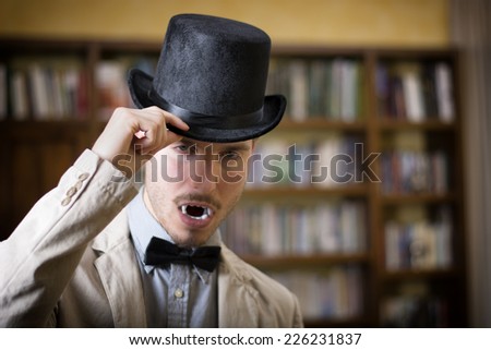 Close up Young Handsome White Vampire with Black Top Hat Inside the Mini Library