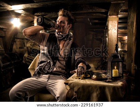 Handsome Rugged Male Pirate Drinking from Bottle in Ship Quarters