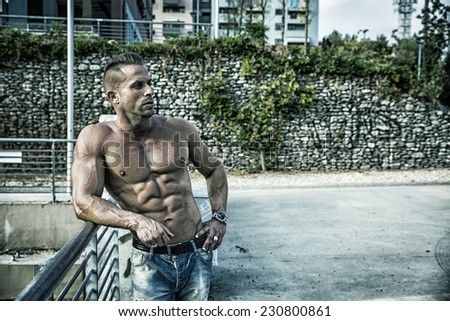 Handsome Muscular Shirtless Hunk Man Outdoor in City Setting. Showing Healthy Body While Looking Away to a Side