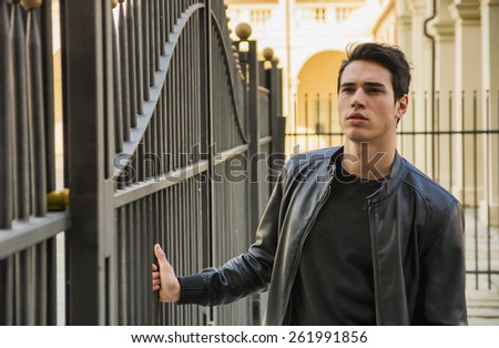 Handsome young man outside historical building in European city (Venaria Reale, near Turin, Italy)