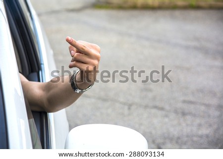 Anonymous Man Making Rude Gesture from Open Car Window, Close Up of Man Flipping the Middle Finger in Anger from Car Window