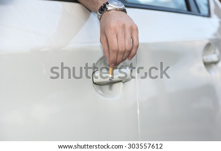 Detail of Man Wearing Wrist Watch Tossing Cigarette Butt Out of Car Window onto Ground, Close Up of Irresponsible Man Littering Garbage from Car