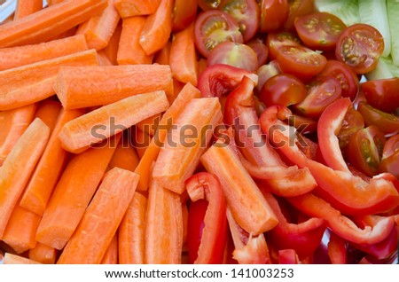 macro of carrots, tomato and pepper sticks