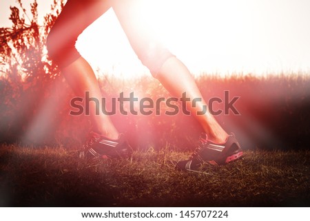 woman running at sunrise with muscular legs woman running at sunrise with muscular legs