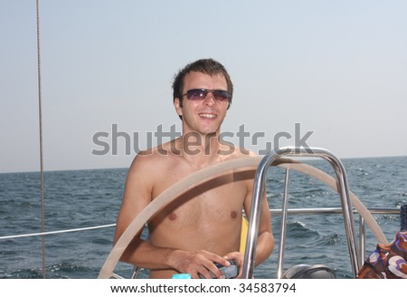 Cool young man at sea on an yacht