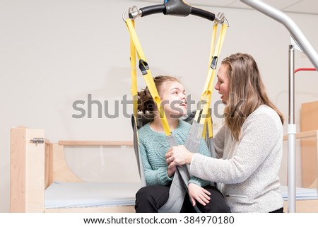 Disabled child together with a special needs carer / Working with disability