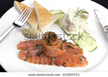 Smoked salmon gravadlax with herbs potato salad cucumber and toast