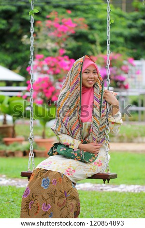 Beautiful muslim women pose with swing in the garden