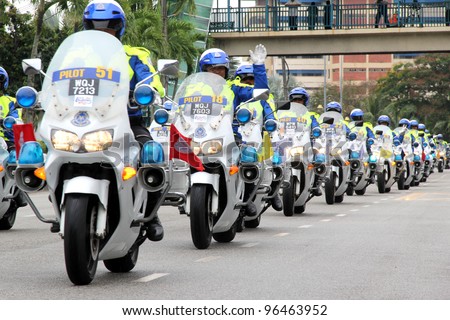 PAHANG, MALAYSIA - MARCH 1: Police traffic marshals queue to escort cyclist during the Race Time which is the seventh stage of Le Tour de Langkawi 2012 on March 1, 2012 in Pahang, Malaysia