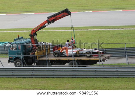 SEPANG, MALAYSIA - MARCH 23: A Team HRT F1 car towed back to the pits after an accident during Friday practice at Petronas Formula 1 Grand Prix March 23, 2012 in Sepang, Malaysia