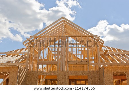 Your Dream Home. New Residential Construction House Framing Against A Blue Sky.