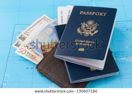 Passports and wallet with dollars, euro and credit card on a map background. Travel concept.