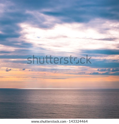 Sky and sun beams on ocean at early morning