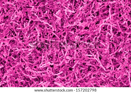 Close-up of pink and magenta shredded paper packaging material background