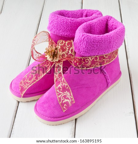 Girls pink winter boots as holiday gift with warm wishes
