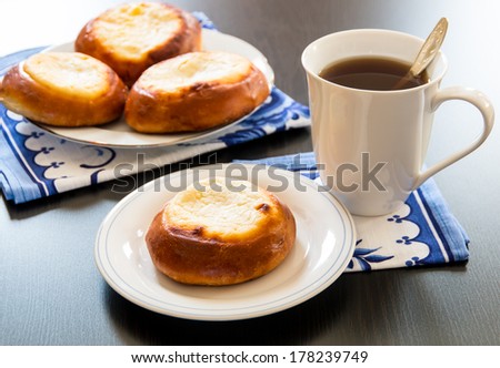 Cottage cheese pastry pies, vatrushka in Russian cuisine. and cup of tea.  selective focus