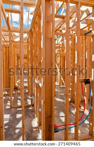 An interior view of a new home under construction with exposed wiring