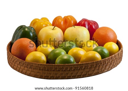 Beautiful tray with colorful fruits and vegetables - bell peppers, apples, oranges, lemons and limes isolated on white