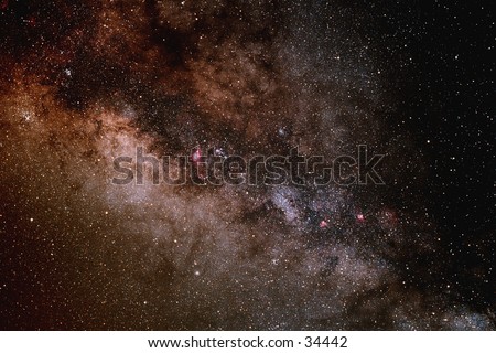 A portion of the central buldge of the Milky Way galaxy showing dense star fields and dark dust lanes.
