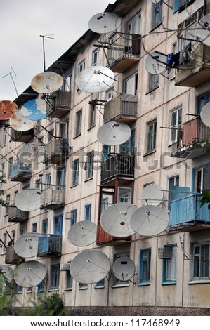 A lot of satellite dishes on the wall.