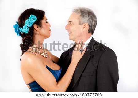Cute mature romantic couple, with man in suit and tie and the woman in a , blue, formal dress