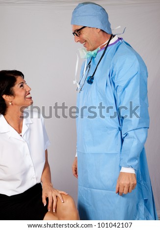 Doctor in scrub gear and his happy nurse