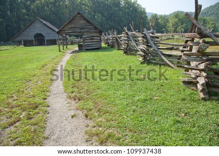 Path to a barn along a weathered split rail fence