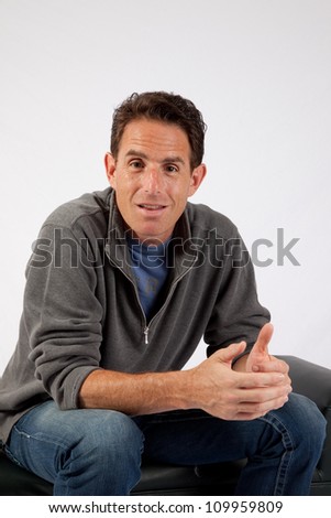Handsome Caucasian mature man with eye contact and a thoughtful, pensive expression