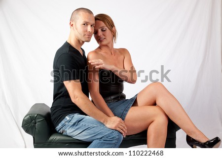 Romantic couple making out as he kisses her cheek and neck