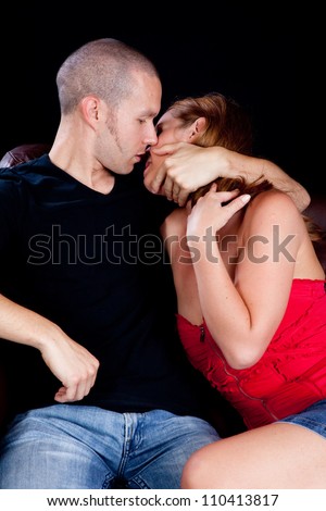 Romantic couple making out on the couch,
