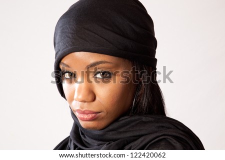 Lovely black woman with eye contact and her head covered like a Muslim