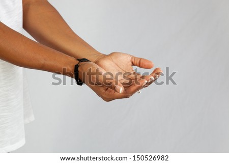 Black woman\'s cupped hands as if to receive a gift