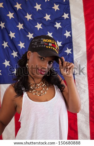 black woman in her grandfathers hat, remembering and taking pride in his service to the United States in WW 2