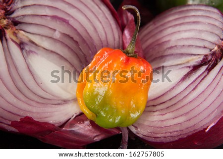 purple onion cut open with pepper