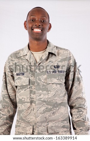 Handsome black man in a United States Air Force fatigues, looking at the camera with a happy expression