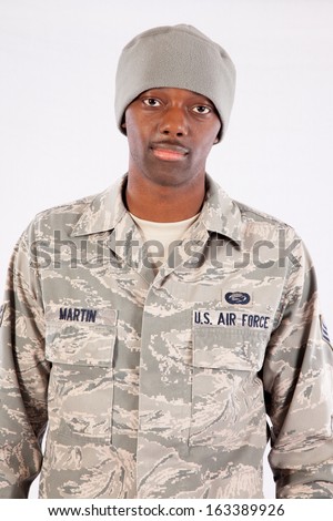 Handsome black man in a United States Air Force fatigues, looking at the camera with a thoughtful expression