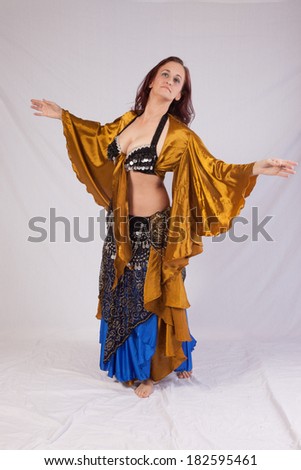 Pretty woman dressed as a belly dancer and dancing with pleasure