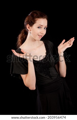 Pretty Caucasian woman looking thoughtfully at the camera with her hand open in a question