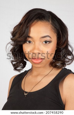 pretty black woman in black tank top,  looking at the camera with a serous expression