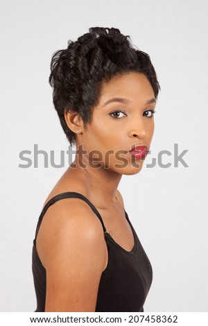 pretty black woman in black tank top   looking at the camera with a serous expression