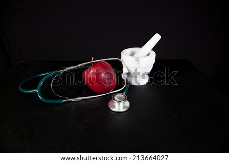 An apple with a stethoscope and mortar and pestle, health-care and pharmacy