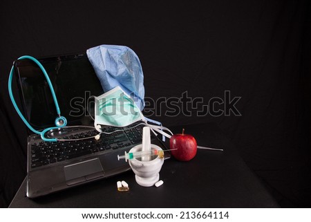 An apple with a stethoscope and mortar and pestle, health-care and pharmacy with a laptop computer with a surgery cap,