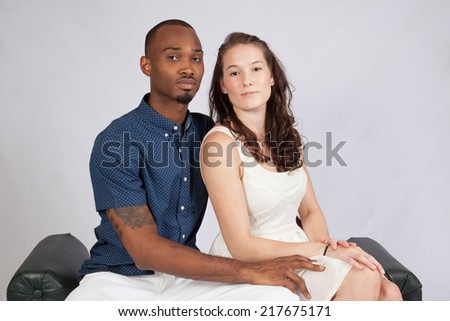 Racially mixed couple, black man and white woman in affectionate embrace and loving touch,
