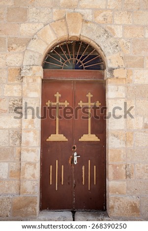 Wooden church doors in a stone wall, from St. George Church in Madaba, Jordan, Middle East