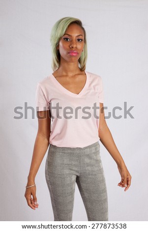 Pretty black woman in pink blouse, looking thoughtfully at the camera