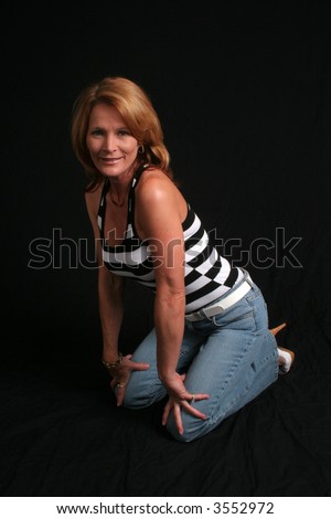 Pretty Mature Woman Kneeling With Hands On Knees Stock Photo