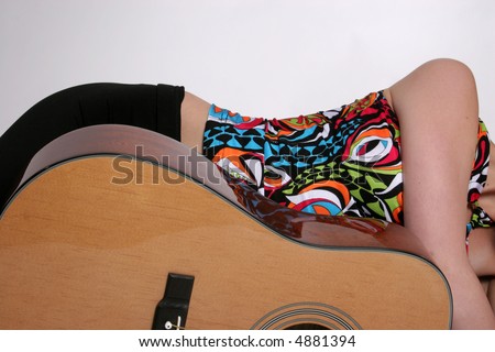 A shapely woman\'s figure compared to a guitar