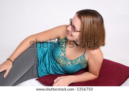 Pretty woman reclining on pillow, looking left