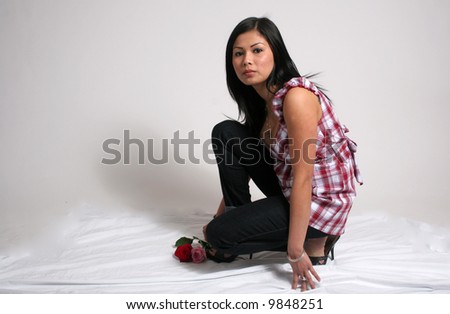 Lovely woman squatting for flowers